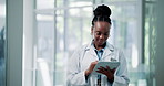 Happy, doctor and black woman in clinic, tablet and typing with connection, internet and tech. African person, medical service and employee in hospital, email or research with app for online schedule