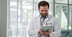 Typing, doctor and man in hospital, tablet and internet with connection, email and medical service. Person, healthcare or professional in clinic, tech or research with website info or online schedule