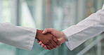 Handshake, welcome and doctors in hospital for partnership, greeting or agreement on treatment plan. Shaking hands, healthcare and surgeons in clinic with collaboration, teamwork or medical deal.
