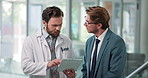 Doctor, tablet or men in hospital, discussion or healthcare with review for treatment. Medical service, support or professional in clinic, tech or feedback for diagnosis, digital app or communication
