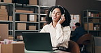 Supply chain, music and woman with headphones in office for distribution, shipping and logistics business. Startup, happy and person listening to song, audio and radio on laptop for delivery website