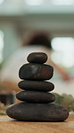 Hot stone, stack and spa at lodge for massage services, relax and holistic treatment for client. Lava rock pile, people and masseuse with physical therapy, wellness or getaway at holiday resort
