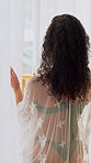 Back, woman and open curtains in hotel with lace robe, swimwear or luxury hospitality for getaway. Person, morning routine and reflection by resort window for vacation start, summer holiday and trip.