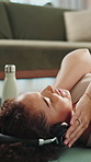 Mindfulness, music and woman with headphones on floor, streaming or listen to audio on break in home. Calm, person and tech for sound, relax and zen with playlist on mat, awareness and song on radio