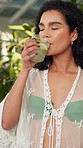 Drinking, travel and woman with cocktail at hotel for summer vacation, getaway or weekend trip. Calm, outdoor and female person enjoying alcohol beverage for break with hospitality at accommodation.
