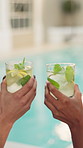 Hands, toast and mojito at pool, celebration and vacation for friends, bonding and memory at lodge. People, glass and drink at hotel with cocktail, alcohol and relax on getaway at holiday resort