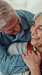 Love, hug and senior man with wife in home for marriage, bonding or connection together. Happy, retirement and elderly couple embracing for relationship, support or care in living room at house.