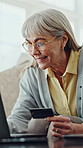 Senior woman, credit card and happy with laptop on sofa, sale or easy payment on web in home. Elderly person, computer and digital banking with fintech, excited or discount deal for online shopping