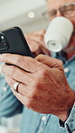 Old man, phone and laugh with coffee in home, texting and happy with notification for funny chat. Senior person, smartphone and hands with mobile app, contact or smile with social media at apartment
