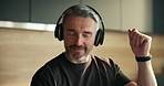 Dance, headphones and mature man in home with audio, music and playlist to relax on weekend. Happy, house and person listening to radio, sound and streaming subscription for positivity in kitchen