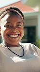 Face, black woman and happy to relax in backyard for weekend break, peaceful morning or fresh air. Smile, person and chill day off in house garden for calm, afternoon rest and unwind with confidence