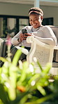 Mobile, smile and black woman relax at backyard with online chat, social media and reading blog. Phone, typing and happy person outdoor by house for text message, ebook app and browsing internet