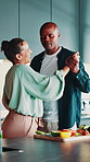 Dance, cooking and couple in kitchen for bonding, fun and loving relationship in home. Happy marriage, romance and man with woman and food, ingredients or meal prep with support for supper or dinner