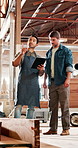 Men, carpenter and tablet at factory, team and planning with talk for furniture manufacturing. People, technician and point with discussion for material, app or design review for project at workshop