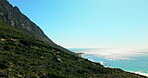 Drone, blue sky and ocean landscape with mountain for travel adventure, nature tourism and space. Aerial, coastline and natural environment with sea view for holiday destination, vacation and scenery