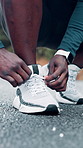 Person, hands or runner tying with shoe on road for workout preparation, exercise or outdoor training. Closeup, fitness and getting ready with sneaker, tie or laces for physical activity on asphalt