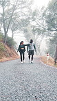 Walking, fitness and couple on road for exercise, cardio workout and talking on weekend. Happy, outdoor and man with woman pointing for wellness, fresh air and conversation for bonding in mist