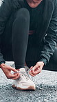 Woman, hands or runner tying with shoe on road for workout preparation, exercise or outdoor training. Closeup, female person or getting ready with sneakers, rain or tie laces for fitness on asphalt