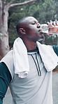 Black man, fitness and break with water bottle in nature for hydration, workout or outdoor exercise. Active, male person or runner with mineral liquid, aqua or beverage for recovery or rest on road