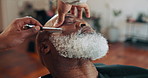 Hands, barber and shave beard with razor for grooming, maintenance or shape with client. Senior man, salon or trim facial hair with tool for beauty, service or hairstylist with customer in barbershop