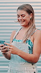 Woman outdoor, typing or laugh with phone for social media joke, funny summer fashion trends or meme. Person, browse and smile with tech in city for popular clothes, internet humor and online gossip.