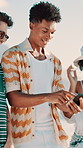 Laughing, phone and scrolling with friends on beach together for reaction to meme or social media post. App, funny and walking with happy people outdoor for communication, connection or gossip