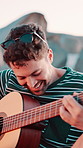 Man outdoor, singing and play guitar for summer holiday, music expression and vacation entertainment. Happy person, musician and song with acoustic instrument skills for weekend trip, relax and fun.