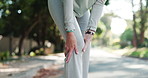 Senior person, hands and knee injury with pain on road for workout accident or emergency. Closeup, elderly or sore bone with leg for muscle tension, bruise or sprain on street in neighborhood town