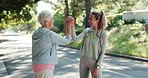 Personal trainer, high five and support with elderly woman in park for mobility training, health or workout team. Friends, success and female fitness coach with senior person in nature for exercise