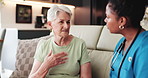 Home, old woman and nurse on sofa, conversation and help with advice, diagnosis and treatment. Pensioner, mature patient or caregiver on couch, medical service and comfort with trust and consultation