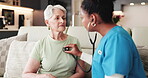 Stethoscope, caregiver or senior woman on sofa for medical evaluation, breathe or listen to heart rate. Retirement, exhale or people in nursing home for health check, lung function assessment or tool