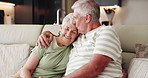 Senior couple, kiss and hug in lounge, people and bonding with smile on couch, retirement and relax. Happy, elderly man and embrace with old woman in living room, affection and romance in house