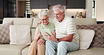 Old couple, scroll and tablet on sofa for social media, streaming or subscription in living room. Elderly man, woman or senior people in house together for retirement, bonding and love with tech