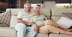 Senior couple, laugh and hug in lounge, people and bonding with smile in house, retirement and love. Happy, elderly man and relax with old woman in living room, talk and romance with partner in home