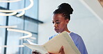 Nurse, folder and results with black woman in hospital for patient history portfolio, medical report and planning. Surgery schedule, checklist and healthcare diagnosis with low angle of person