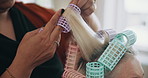 Woman, hands and hairdresser with hair curlers in beauty salon for styling, curls or volume. Closeup, female person or rollers with treatment or curling for haircare, style or grooming in parlor