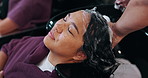 Woman, washing or hair with massage in salon above for grooming, spa or haircare treatment. Top view, female person or customer with hairdresser with soap for cleaning or keratin in beauty parlor