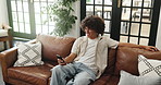 Happy, above and man on sofa with phone for social media, online chatting and communication. Relax, home and person on smartphone for internet, website and networking in living room on weekend