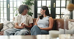 Couple, relax and talking on couch in home for first date, explain interests and bonding together. Smile, people and discussion on couch for commitment, romantic conversation and connection in lounge