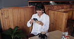 Business woman, phone and laugh in cafe for break, social media notification and funny joke. Freelancer, meme and tech with internet for comedy, website or review in coffee shop for project proposal