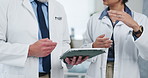 Hands, doctors and tablet with team, planning and discussion with review, feedback or report at clinic. People, medical professional and explain with app, insight and healthcare solution at hospital