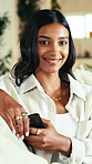 Face, phone and relax with woman in home living room for internet or social media browsing. App, break and text message with happy Indian person in apartment for communication or me time wellness