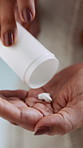 Hands, woman and pills for medicine, health or prescription drugs with antibiotics for wellness. Palm, medication bottle and person with supplements, vitamins and medical benefits with cure closeup