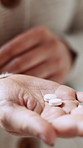 Hands, woman and pills for medicine, wellness product or prescription drugs in home. Palm, medication and person with tablets for supplements, healthy vitamins or medical benefits with cure closeup