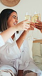 Cheers, happy and friends in hotel with champagne, bonding and congratulations on bachelorette trip. Smile, women and bridesmaid at resort with toast, sparkling wine or celebration at bridal shower.