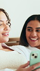 Gossip, smile or friends in hotel with phone, conversation or bonding together in social media scroll. Laugh, sleepover or women in bed with chatting, app browsing or internet search at resort.