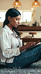 Typing, communication or Indian woman on floor with laptop, agenda review or research in remote work. Digital, WFH or freelancer in house with tech, planning or schedule update in task management.