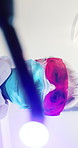 Face, dentist and woman with light, surgery and dental mask for tooth extraction and oral procedure. Low angle, orthodontist and mature person with safety glasses for operation and teeth inspection
