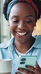 Black woman, phone and coffee in home, laugh and scroll for funny meme, chat or contact in morning. African person, smartphone and smile with mobile app, texting or video on web with tea at apartment