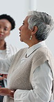 Woman, team and meeting with discussion, planning or review at board at risk management company. Mature person, group and problem solving in office with notes, insight or feedback at insurance agency